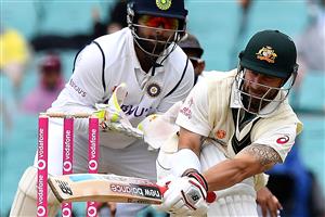 Australian batsman Matthew Wade plays a shot as Indian wicketkeeper Rishabh Pant (L) looks on during the day two of the third cricket Test match at Sydney Cricket Ground (SCG) between Australia and India on January 8, 2021. (Photo by Saeed KHAN / AFP) / --IMAGE RESTRICTED TO EDITORIAL USE - NO COMMERCIAL USE-- (Photo by SAEED KHAN/AFP via Getty Images)