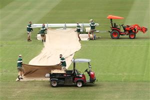 SYDNEY, AUSTRALIA - JANUARY 08: Groundsmen cover the pitch during a rain delay during day two of the Third Test match in the series between Australia and India at Sydney Cricket Ground on January 08, 2021 in Sydney, Australia. (Photo by Cameron Spencer/Getty Images)