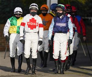 SUNBURY, ENGLAND - JANUARY 09: A general view as jockeys make their way to the parade ring at Kempton Park Racecourse on January 09, 2021 in Sunbury, England. Due to the Coronavirus pandemic, owners along with the paying public will not be allowed to attend the meeting. (Photo by Alan Crowhurst/Getty Images)