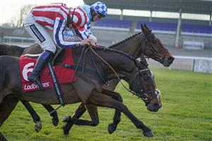 SUNBURY, ENGLAND - JANUARY 09: James Bowen riding Double Shuffle (blue) clear the last to win The Ladbrokes Committed To Safer Gambling Handicap Chase from Lily Pinchin riding Ami Desbois who pecks on landing at Kempton Park Racecourse on January 09, 2021 in Sunbury, England. Due to the Coronavirus pandemic, owners along with the paying public will not be allowed to attend the meeting. (Photo by Alan Crowhurst/Getty Images)