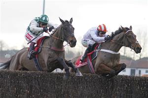 SUNBURY, ENGLAND - JANUARY 09: Richard Johnson riding Smarty Wild (L) clear the last to win The Ladbrokes Where The Nation Plays Handicap Chase from Nico de Boinville and Pistol Whipped at Kempton Park Racecourse on January 09, 2021 in Sunbury, England. Due to the Coronavirus pandemic, owners along with the paying public will not be allowed to attend the meeting. (Photo by Alan Crowhurst/Getty Images)