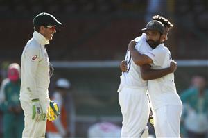 SYDNEY, AUSTRALIA - JANUARY 11: Tim Paine of Australia watches on as Ravichandran Ashwin of India embraces his captain Ajinkya Rahane of India as they celebrate securing a draw during day five of the Third Test match in the series between Australia and India at Sydney Cricket Ground on January 11, 2021 in Sydney, Australia. (Photo by Mark Kolbe/Getty Images)