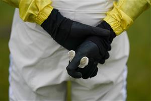 PLUMPTON, ENGLAND - JANUARY 13: A jockey holds his gumshield whilst talking to the trainer at Plumpton Racecourse on January 13, 2021 in Plumpton, England. Due to the Coronavirus pandemic, owners along with the paying public will not be allowed to attend the meeting. (Photo by Alan Crowhurst/Getty Images)
