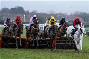 PLUMPTON, ENGLAND - JANUARY 13: Kielan Woods riding Lady Chuffnell (C, pink) on their way to winning The Visit attheraces.com Handicap Hurdle at Plumpton Racecourse on January 13, 2021 in Plumpton, England. Due to the Coronavirus pandemic, owners along with the paying public will not be allowed to attend the meeting. (Photo by Alan Crowhurst/Getty Images)