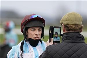 PLUMPTON, ENGLAND - JANUARY 13: Trainer Jamie Snowden holds a phone while jockey Gavin Sheehan makes a video for connections after finishing in The Tie The Knot Wedding Catering Novices' Hurdle at Plumpton Racecourse on January 13, 2021 in Plumpton, England. Due to the Coronavirus pandemic, owners along with the paying public will not be allowed to attend the meeting. (Photo by Alan Crowhurst/Getty Images)