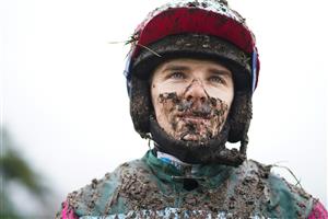 FONTWELL, ENGLAND - JANUARY 14: A wet and Muddy Micheal Nolan after riding in the first at Fontwell Park Racecourse on January 14, 2021 in Fontwell, England. Due to the Coronavirus pandemic, owners along with the paying public will not be allowed to attend the meeting. (Photo by Alan Crowhurst/Getty Images)