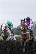 WARWICK, ENGLAND - JANUARY 16: Tom Cannon riding Notachance (pink) clear the last to win The McCoy Contractors Civil Engineering Classic Handicap Chase at Warwick Racecourse on January 16, 2021 in Warwick, England. Due to the Coronavirus pandemic, owners along with the paying public will not be allowed to attend the meeting. (Photo by Alan Crowhurst/Getty Images)