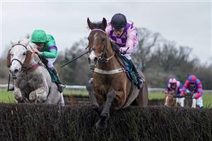 WARWICK, ENGLAND - JANUARY 16: Tom Cannon riding Notachance (pink) clear the last to win The McCoy Contractors Civil Engineering Classic Handicap Chase at Warwick Racecourse on January 16, 2021 in Warwick, England. Due to the Coronavirus pandemic, owners along with the paying public will not be allowed to attend the meeting. (Photo by Alan Crowhurst/Getty Images)