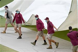 BRISBANE, AUSTRALIA - JANUARY 18: The covers are seen being put on the pitch as rain delays play during day four of the 4th Test Match in the series between Australia and India at The Gabba on January 18, 2021 in Brisbane, Australia. (Photo by Bradley Kanaris/Getty Images)