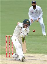 BRISBANE, AUSTRALIA - JANUARY 18: David Warner of Australia plays a shot during day four of the 4th Test Match in the series between Australia and India at The Gabba on January 18, 2021 in Brisbane, Australia. (Photo by Bradley Kanaris/Getty Images)
