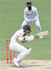 BRISBANE, AUSTRALIA - JANUARY 18: David Warner of Australia ducks a bouncer during day four of the 4th Test Match in the series between Australia and India at The Gabba on January 18, 2021 in Brisbane, Australia. (Photo by Bradley Kanaris/Getty Images)