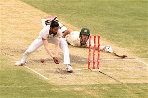 BRISBANE, AUSTRALIA - JANUARY 18: Mohammed Siraj of India fields as Pat Cummins of Australia makes his ground during day four of the 4th Test Match in the series between Australia and India at The Gabba on January 18, 2021 in Brisbane, Australia. (Photo by Matt Roberts/Getty Images)