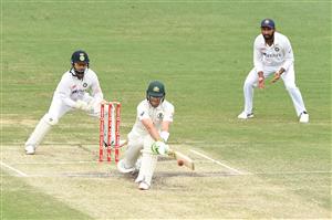 BRISBANE, AUSTRALIA - JANUARY 18: Tim Paine of Australia bats during day four of the 4th Test Match in the series between Australia and India at The Gabba on January 18, 2021 in Brisbane, Australia. (Photo by Matt Roberts/Getty Images)
