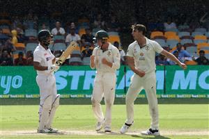 BRISBANE, AUSTRALIA - JANUARY 19: Pat Cummins of Australia and team mates celebrate taking the wicket of Cheteshwar Pujara during day five of the 4th Test Match in the series between Australia and India at The Gabba on January 19, 2021 in Brisbane, Australia. (Photo by Bradley Kanaris/Getty Images)