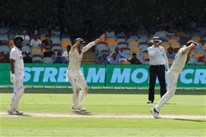 BRISBANE, AUSTRALIA - JANUARY 19: Pat Cummins of Australia and team mates celebrate taking the wicket of Cheteshwar Pujara during day five of the 4th Test Match in the series between Australia and India at The Gabba on January 19, 2021 in Brisbane, Australia. (Photo by Bradley Kanaris/Getty Images)