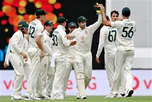 BRISBANE, AUSTRALIA - JANUARY 19: Pat Cummins of Australia and team mates celebrate taking the wicket of Rohit Sharma of India during day five of the 4th Test Match in the series between Australia and India at The Gabba on January 19, 2021 in Brisbane, Australia. (Photo by Bradley Kanaris/Getty Images)