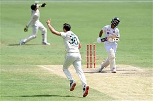 BRISBANE, AUSTRALIA - JANUARY 19: Pat Cummins of Australia celebrates taking the wicket of Ajinkya Rahane of India during day five of the 4th Test Match in the series between Australia and India at The Gabba on January 19, 2021 in Brisbane, Australia. (Photo by Bradley Kanaris/Getty Images)