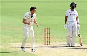 BRISBANE, AUSTRALIA - JANUARY 19: Pat Cummins of Australia and team mates celebrate taking the wicket of Cheteshwar Pujara during day five of the 4th Test Match in the series between Australia and India at The Gabba on January 19, 2021 in Brisbane, Australia. (Photo by Bradley Kanaris/Getty Images)