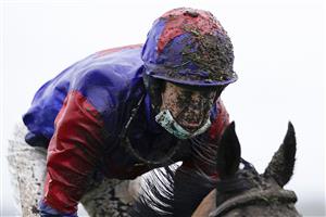 NEWBURY, ENGLAND - JANUARY 20: A wet and muddy Robert Dunne at Newbury Racecourse on January 20, 2021 in Newbury, England. Due to the Coronavirus pandemic, owners along with the paying public will not be allowed to attend the meeting. (Photo by Alan Crowhurst/Getty Images)