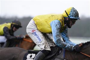 NEWBURY, ENGLAND - JANUARY 20: Jockey Lorcan Williams, wet and muddy at Newbury Racecourse on January 20, 2021 in Newbury, England. Due to the Coronavirus pandemic, owners along with the paying public will not be allowed to attend the meeting. (Photo by Alan Crowhurst/Getty Images)