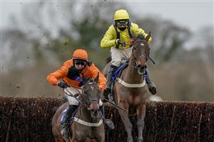 WINCANTON, ENGLAND - JANUARY 21: Niall Houlihan riding Mister Murchan (orange) clear the last to win The Follow racingtv On Instagram Novices' Handicap Chase at Wincanton Racecourse on January 21, 2021 in Wincanton, England. Due to the Coronavirus pandemic, owners along with the paying public will not be allowed to attend the meeting. (Photo by Alan Crowhurst/Getty Images)