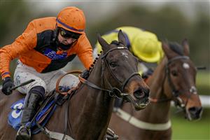 WINCANTON, ENGLAND - JANUARY 21: Niall Houlihan riding Mister Murchan (orange) clear the last to win The Follow racingtv On Instagram Novices' Handicap Chase at Wincanton Racecourse on January 21, 2021 in Wincanton, England. Due to the Coronavirus pandemic, owners along with the paying public will not be allowed to attend the meeting. (Photo by Alan Crowhurst/Getty Images)