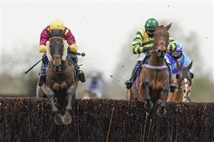 WINCANTON, ENGLAND - JANUARY 21: David Noonan riding Favori de Sivola (L, yellow, maroon) clear the last to win The Use The racingtv.com Tracker Handicap Chase at Wincanton Racecourse on January 21, 2021 in Wincanton, England. Due to the Coronavirus pandemic, owners along with the paying public will not be allowed to attend the meeting. (Photo by Alan Crowhurst/Getty Images)