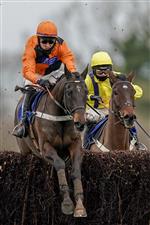 WINCANTON, ENGLAND - JANUARY 21: Niall Houlihan riding Mister Murchan (orange) clear the last to win The Follow racingtv On Instagram Novices' Handicap Chase at Wincanton Racecourse on January 21, 2021 in Wincanton, England. Due to the Coronavirus pandemic, owners along with the paying public will not be allowed to attend the meeting. (Photo by Alan Crowhurst/Getty Images)