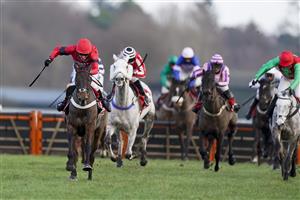 ASCOT, ENGLAND - JANUARY 23: Tom Cannon riding Craigneiche (red) clear the last to win The Matchbook Better Way To Bet Holloway's Handicap Hurdle at Ascot Racecourse on January 23, 2021 in Ascot, England. Due to the Coronavirus pandemic, owners along with the paying public will not be allowed to attend the meeting. (Photo by Alan Crowhurst/Getty Images)