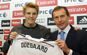 Sixteen-year-old Norwegian midfielder Martin Oedegaard (L) poses with Real Madrid Director of Institutional Relations Emilio Butragueno during his official presentation at the Valdebebas Ciudad Real Madrid in Madrid on January 22, 2015. A complete unknown only a year ago, Norwegian prodigy Martin Odeegaard