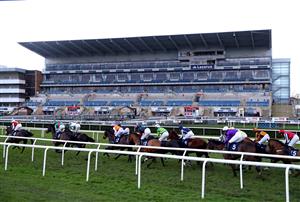 DONCASTER, ENGLAND - JANUARY 29: Runners and riders pass the empty grandstand as they compete in the First Race Special On Sky Bet Tomorrow Novices' Hurdle at Doncaster Racecourse on January 29, 2021 in Doncaster, England. (Photo by Tim Goode - Pool/Getty Images)