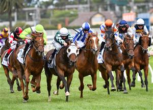 MELBOURNE, AUSTRALIA - JANUARY 30: Jordan Childs riding Long Arm (L) to win Race 7, the Here For The Horses Handicap, during Melbourne Racing at Caulfield Racecourse on January 30, 2021 in Melbourne, Australia. (Photo by Vince Caligiuri/Getty Images)