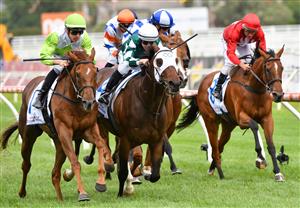 MELBOURNE, AUSTRALIA - JANUARY 30: Jordan Childs riding Long Arm (L) to win Race 7, the Here For The Horses Handicap, during Melbourne Racing at Caulfield Racecourse on January 30, 2021 in Melbourne, Australia. (Photo by Vince Caligiuri/Getty Images)