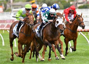 MELBOURNE, AUSTRALIA - JANUARY 30: Jordan Childs riding Long Arm (L) to win Race 7, the Here For The Horses Handicap, during Melbourne Racing at Caulfield Racecourse on January 30, 2021 in Melbourne, Australia. (Photo by Vince Caligiuri/Getty Images)
