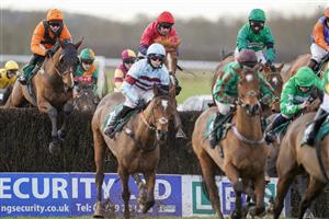 WARWICK, ENGLAND - FEBRUARY 03: Callum Bewley riding Overworkdunderpaid (L, orange) on their way to winning The South West Syndicate Novices' Handicap Chase at Warwick Racecourse on February 03, 2021 in Warwick, England. Due to the Coronavirus pandemic, owners along with the paying public will not be allowed to attend the meeting. (Photo by Alan Crowhurst/Getty Images)