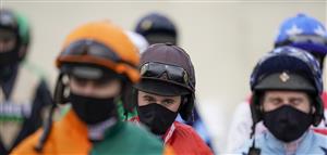 WINCANTON, ENGLAND - FEBRUARY 04: A general view of masked jockeys at Wincanton Racecourse on February 04, 2021 in Wincanton, England. Due to the Coronavirus pandemic, owners along with the paying public will not be allowed to attend the meeting. (Photo by Alan Crowhurst/Getty Images)