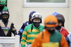 WINCANTON, ENGLAND - FEBRUARY 04 Jonjo O'Neill Jr. (green) makes his way to the parade ring before riding Time To Get Up to win The Dick Hunt Handicap Chase at Wincanton Racecourse on February 04, 2021 in Wincanton, England. Due to the Coronavirus pandemic, owners along with the paying public will not be allowed to attend the meeting. (Photo by Alan Crowhurst/Getty Images)