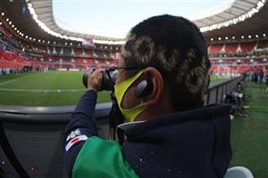 A picture shows the message "Covid Goodbye" dyed into the hair of a photographer covering the FIFA Club World Cup second round football match between Mexico