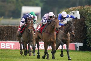 ESHER, ENGLAND - FEBRUARY 06: David Bass riding Moonlighter (C, pink) clear the last to win The Virgin Bet Handicap Chase at Sandown Park Racecourse on February 06, 2021 in Esher, England. Due to the Coronavirus pandemic, owners along with the paying public will not be allowed to attend the meeting. (Photo by Alan Crowhurst/Getty Images)
