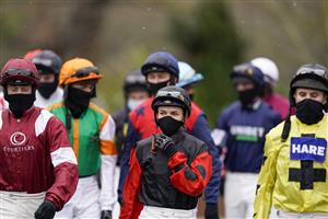 SUNBURY, ENGLAND - FEBRUARY 09: Megan Nicholls (C) makes her way to the parade ring at Kempton Park Racecourse on February 09, 2021 in Sunbury, England. Due to the Coronavirus pandemic, owners along with the paying public will not be allowed to attend the meeting. (Photo by Alan Crowhurst/Getty Images)