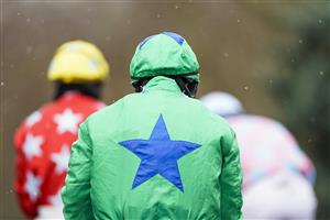 SUNBURY, ENGLAND - FEBRUARY 09: A general view as runners make their way to the track as a light snow falls at Kempton Park Racecourse on February 09, 2021 in Sunbury, England. Due to the Coronavirus pandemic, owners along with the paying public will not be allowed to attend the meeting. (Photo by Alan Crowhurst/Getty Images)