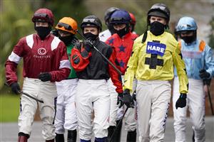 SUNBURY, ENGLAND - FEBRUARY 09: Megan Nicholls (C) makes her way to the parade ring at Kempton Park Racecourse on February 09, 2021 in Sunbury, England. Due to the Coronavirus pandemic, owners along with the paying public will not be allowed to attend the meeting. (Photo by Alan Crowhurst/Getty Images)
