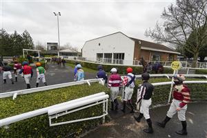 SUNBURY, ENGLAND - FEBRUARY 09: A general view as jockeys enter the parade ring at Kempton Park Racecourse on February 09, 2021 in Sunbury, England. Due to the Coronavirus pandemic, owners along with the paying public will not be allowed to attend the meeting. (Photo by Alan Crowhurst/Getty Images)