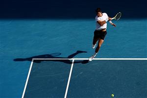 MELBOURNE, AUSTRALIA - FEBRUARY 11: Thanasi Kokkinakis of Australia plays a forehand in his Men