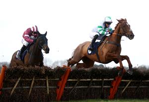 WETHERBY, ENGLAND - FEBRUARY 17: Nightboattoclyro ridden by Robert Dunne (right) clears a fence on their way to winning the racingtv.com Handicap Hurdle at Wetherby Racecourse on February 17, 2021 in Wetherby, England. (Photo by Pool/Getty Images)