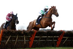 WETHERBY, ENGLAND - FEBRUARY 17: Nightboattoclyro ridden by Robert Dunne (right) clears a fence on their way to winning the racingtv.com Handicap Hurdle at Wetherby Racecourse on February 17, 2021 in Wetherby, England. (Photo by Pool/Getty Images)