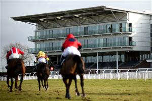 WETHERBY, ENGLAND - FEBRUARY 17: Runners and riders pass the empty grandstand as they compete in the Sixt Car Hire Handicap Chase at Wetherby Racecourse on February 17, 2021 in Wetherby, England. (Photo by Tim Goode - Pool/Getty Images)
