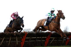 WETHERBY, ENGLAND - FEBRUARY 17: Nightboattoclyro ridden by Robert Dunne (right) clears a fence on their way to winning the racingtv.com Handicap Hurdle at Wetherby Racecourse on February 17, 2021 in Wetherby, England. (Photo by Pool/Getty Images)
