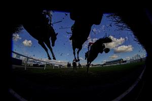 WARWICK, ENGLAND - FEBRUARY 26: A general view as runners clear a fence in the straight during The Watch On Racing TV Novices' Handicap Chase at Warwick Racecourse on February 26, 2021 in Warwick, England. Due to the coronavirus pandemic, owners along with the paying public will not be allowed to attend the meeting. (Photo by Alan Crowhurst/Getty Images)