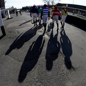SUNBURY, ENGLAND - FEBRUARY 27: A general view as jockeys make their way to the parade ring on a sunny afternoon at Kempton Park Racecourse on February 27, 2021 in Sunbury, England. Due to the coronavirus pandemic, owners along with the paying public will not be allowed to attend the meeting. (Photo by Alan Crowhurst/Getty Images)